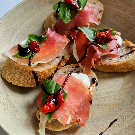 Prosciutto and basil crostini with balsamic