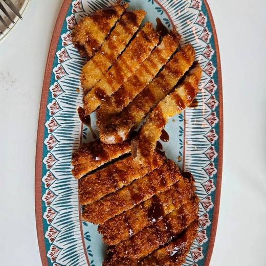 Breaded cutlet, sliced and sauced
