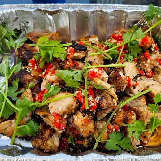 Grilled chicken with chilli and coriander in a catering tray