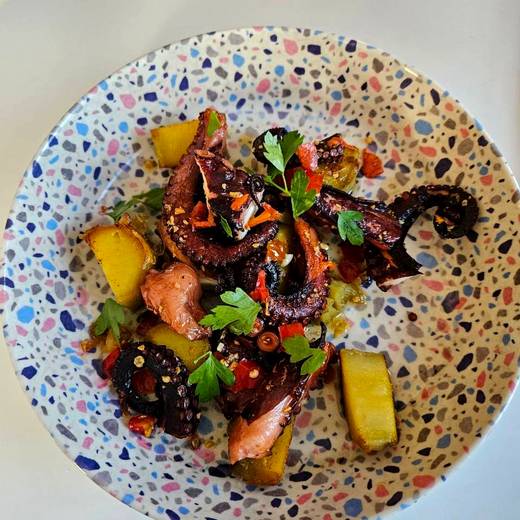 Grilled octopus with roasted potatoes and peppers