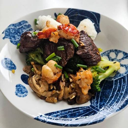 Steak and lobster with mushrooms and broccoli